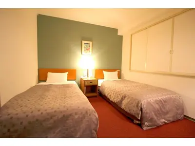 a room with two beds and a lamp in it at Smile Hotel Tokyo Shinkoiwa - Vacation STAY 82190v in Tokyo