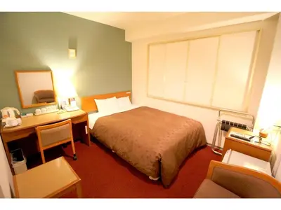 a bedroom with a bed and a desk with a mirror at Smile Hotel Tokyo Shinkoiwa - Vacation STAY 82189v in Tokyo