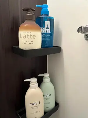 three bottles of laundry detergent and bleach on shelves in a bathroom at YOYOGIHOUSE - Vacation STAY 19984 in Tokyo