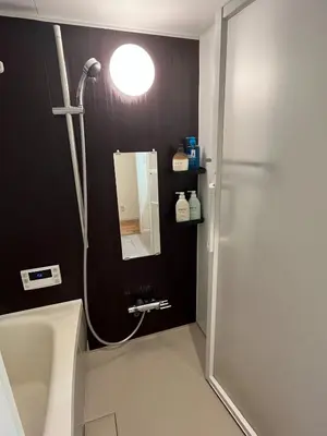 a bathroom with a shower and a sink and a mirror at YOYOGIHOUSE - Vacation STAY 19984 in Tokyo