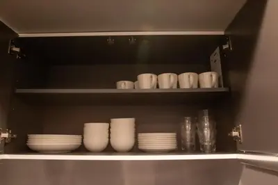 a shelf with white cups and plates on it at ECORO Shinjuku Dai2 Building 2F - Vacation STAY 20114 in Tokyo
