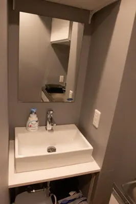 a bathroom with a white sink and a mirror at ECORO Shinjuku Dai2 Building 2F - Vacation STAY 20114 in Tokyo