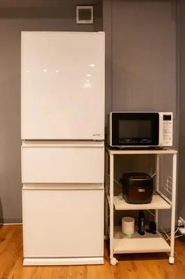 a white refrigerator and a microwave on a shelf at ECORO Shinjuku Dai2 Building 2F - Vacation STAY 20114 in Tokyo