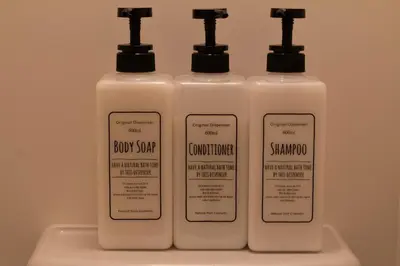 three bottles of soap and shampoo on a shelf at ECORO Shinjuku Dai2 Building 2F - Vacation STAY 20114 in Tokyo