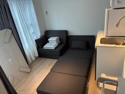 a small living room with a couch and a table at 12 \u3068\u308a\u3063\u3071\u30fc\u305a\u30db\u30c6\u30eb\u9ad8\u7530\u99ac\u5834 in Tokyo
