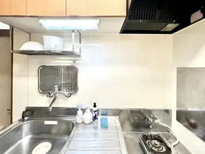 a kitchen with a stainless steel sink and a stove at TD House 3-min Walk Easy Access Shinjuku, Shibuya, Asakusa, Ueno in Tokyo