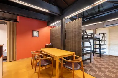 a room with a table and chairs and a ladder at SHINJUKU Garden-house in Tokyo
