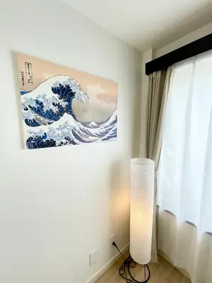 a room with a painting of a wave on the wall at Sakura Stays Tokyo - Stay Together with Privacy - Ideal Group Accommodation in Tokyo