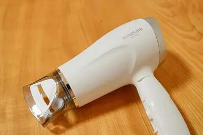 a white electric hair dryer sitting on a wooden table at Roseheim 2 kamiochiai in Tokyo