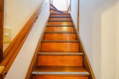 a stairway in a building with wooden stairs at Roseheim 2 kamiochiai in Tokyo