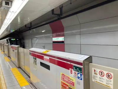 a subway train station with a line of machines at Roseheim 2 kamiochiai in Tokyo