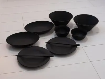 a group of black bowls on a tiled floor at Tokyo Kaminarimon House Asakusa in Tokyo