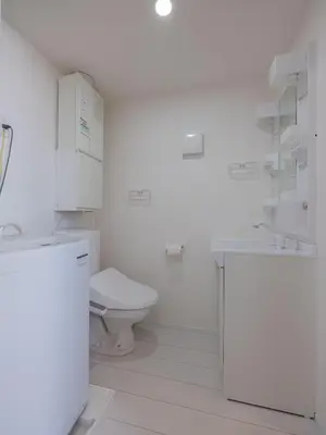 a white bathroom with a toilet and a sink at Tokyo Kaminarimon House Asakusa in Tokyo