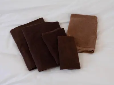 two pieces of brown cloth sitting on a bed at Tokyo Kaminarimon House Asakusa in Tokyo