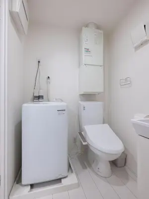 a white bathroom with a toilet and a sink at Tokyo Kaminarimon House Asakusa in Tokyo