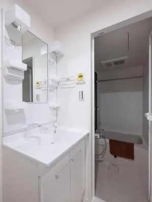 a white bathroom with a sink and a mirror at Tokyo Kaminarimon House Asakusa in Tokyo