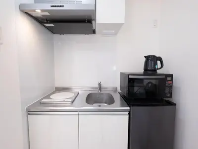 a kitchen with a sink and a microwave at Tokyo Kaminarimon House Asakusa in Tokyo