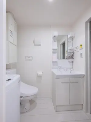 a white bathroom with a toilet and a sink at Tokyo Kaminarimon House Asakusa in Tokyo