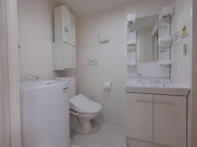 a white bathroom with a toilet and a sink at Tokyo Kaminarimon House Asakusa in Tokyo
