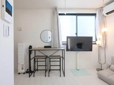 a living room with a table and a mirror at Tokyo Kaminarimon House Asakusa in Tokyo