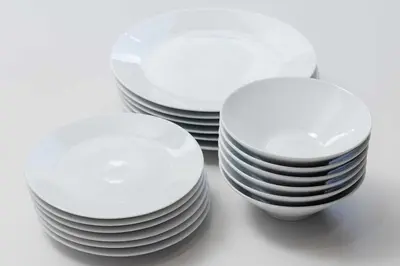 three stacks of white plates sitting on a table at KOKOON Hotel Shibuya 201 in Tokyo