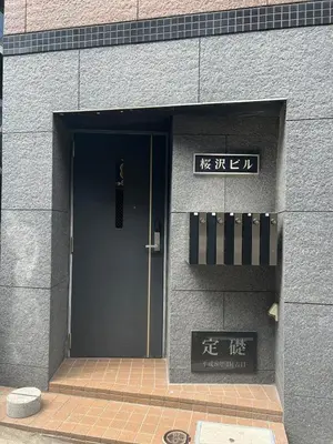 a door to a building with asian writing on it at KOKOON Hotel Shibuya 201 in Tokyo