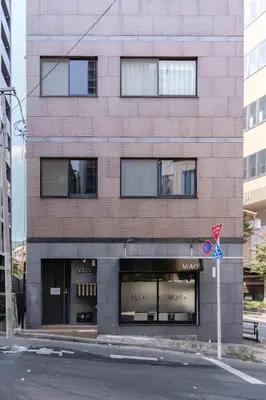 a tall brick building with windows on a street at KOKOON Hotel Shibuya 201 in Tokyo