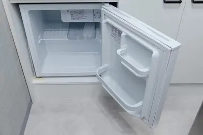 an empty refrigerator with its door open in a kitchen at KOKOON Hotel Shibuya 301 in Tokyo