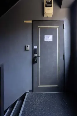 a elevator door with a sign on it in a room at KOKOON Hotel Shibuya 301 in Tokyo