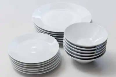 three stacks of white plates sitting on a table at KOKOON Hotel Shibuya 401 in Tokyo