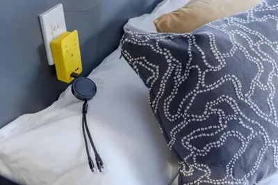 a bed with a pillow with a magnifier on it at KOKOON Hotel Shibuya 401 in Tokyo