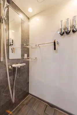 a shower with a glass door in a bathroom at KOKOON Hotel Shibuya 401 in Tokyo