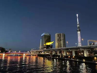 a view of a city at night with a bridge and buildings at \u30b2\u30b9\u30c8\u30cf\u30a6\u30b9\u66f3\u821f in Tokyo