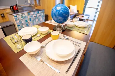 a table with white plates and a blue balloon on it at Voyager Inn in Tokyo