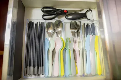 a drawer with forks and spoons and scissors at Voyager Inn in Tokyo