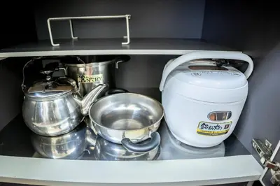 a shelf with pots and pans and a mixer at Voyager Inn in Tokyo
