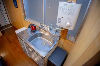 a bathroom with a sink in a room at Voyager Inn in Tokyo