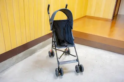 a stroller parked in a basketball court at Voyager Inn in Tokyo
