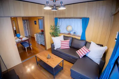 a living room with a couch and a table at Voyager Inn in Tokyo