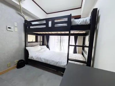 two bunk beds in a room with a window at East-Nihonbashi House 2bed Travel Work in Tokyo