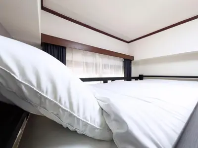 a bedroom with two beds with white pillows at East-Nihonbashi House 2bed Travel Work in Tokyo
