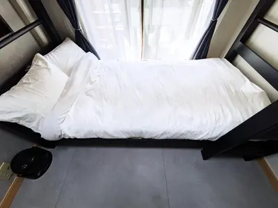 a white bed in a small room with a window at East-Nihonbashi House 2bed Travel Work in Tokyo
