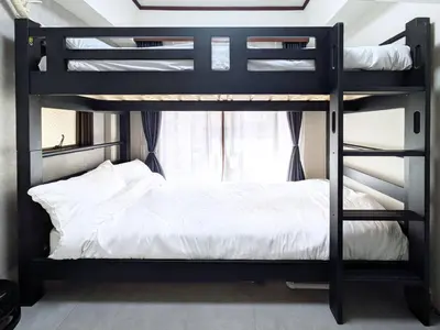 a bunk bed in a room with a black bunk bed at East-Nihonbashi House 2bed Travel Work in Tokyo