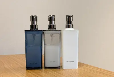 three bottles ofodorizers sitting on a wooden table at CHOCKY Nishi-Shinjuku in Tokyo