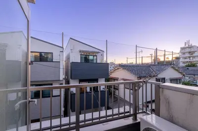 a balcony with a view of some buildings at CHOCKY Nishi-Shinjuku in Tokyo