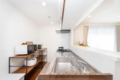 a white kitchen with a sink and a microwave at \u30eb\u30eb\u30df\u30a8\u30fc\u30eb\u4e21\u56fd in Tokyo