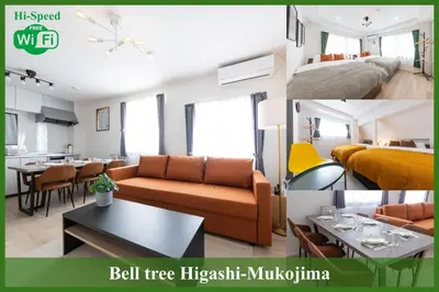 a room with a couch and a bed and a table at Bell tree Higashi-Mukojima in Tokyo