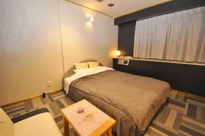 a small room with a bed and a table at Hotel Boston Club (Adult Only) in Tokyo