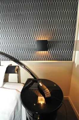 a desk with a phone on a table next to a bed at Hotel Boston Club (Adult Only) in Tokyo