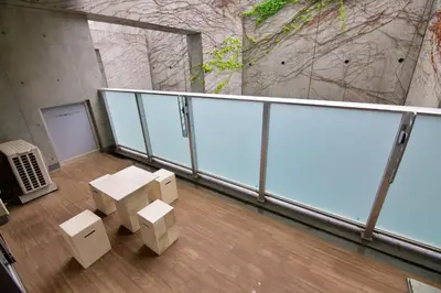 a balcony with boxes on the floor of a building at \u9ebb\u5e03\u5341\u756a\u99c5\u5f92\u6b695\u5206 in Tokyo